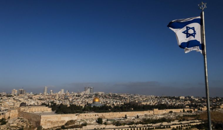 An Israeli flag flies on the Mount of Olives overlooking the Al Aqsa mosque compound and the city skyline in Jerusalem on April 19, 2024
